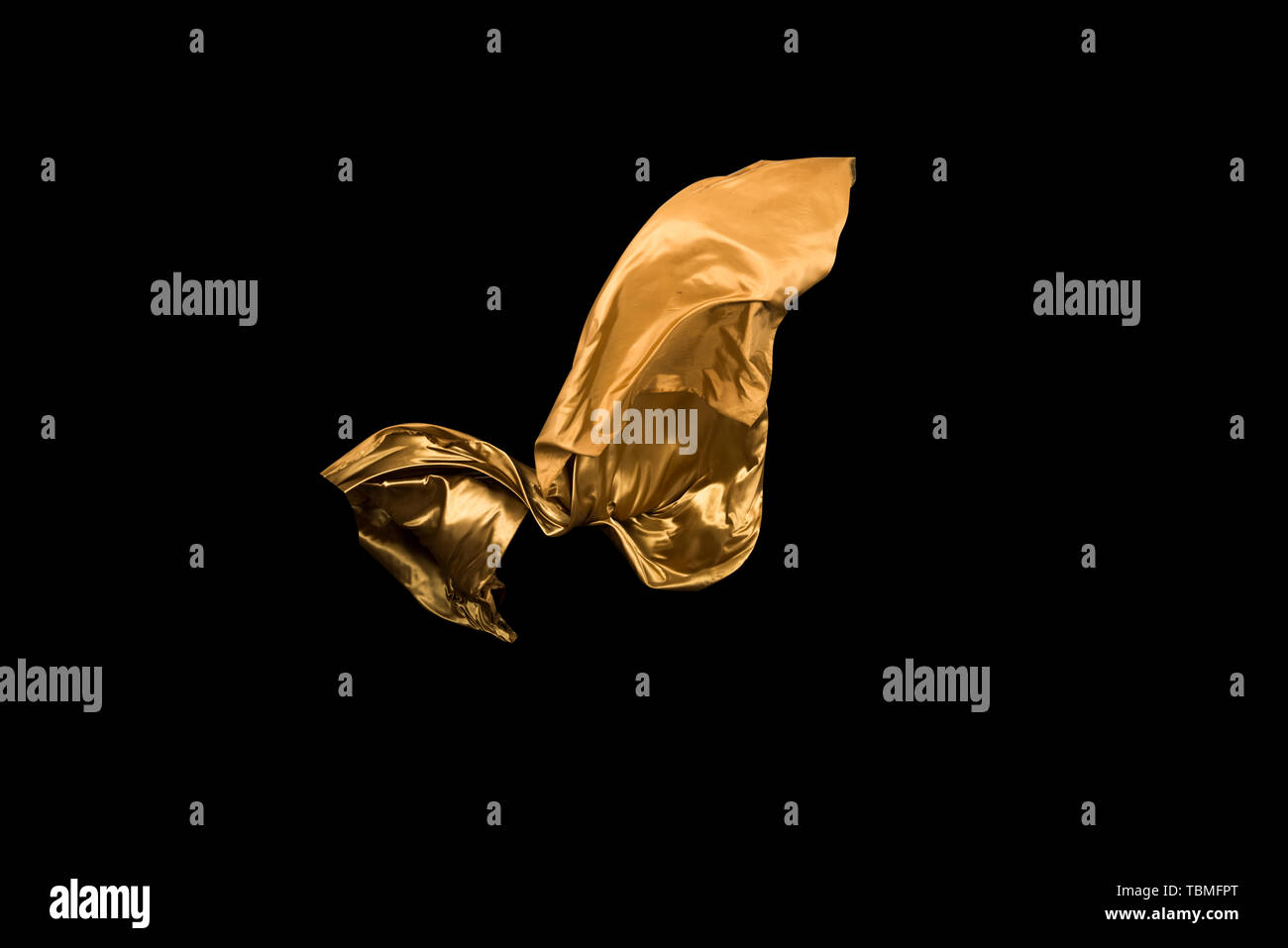 golden soft satin flying in wind on background Stock Photo