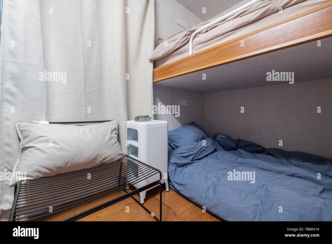 Simple bed with soft quilt Stock Photo - Alamy