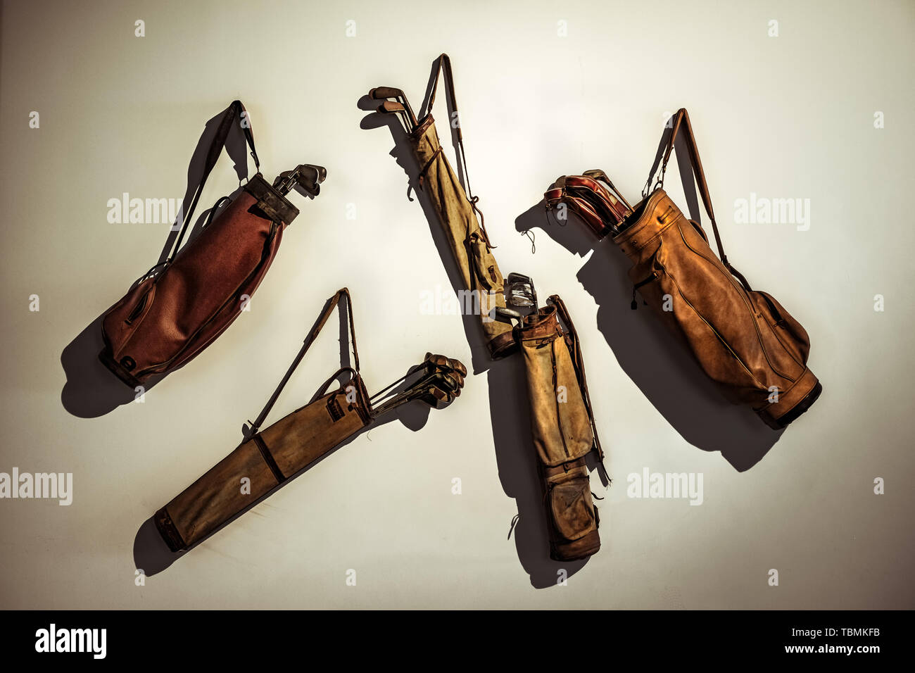 Set of old vintage golf clubs in bag hanging on the wall Stock Photo