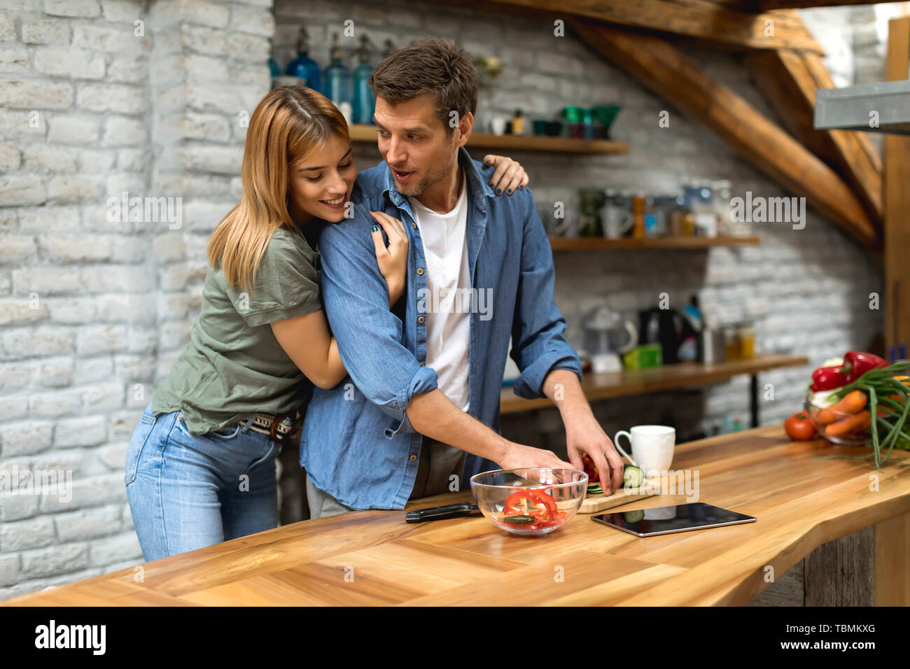 Lovely couple preparing food  in the kitchen Stock Photo