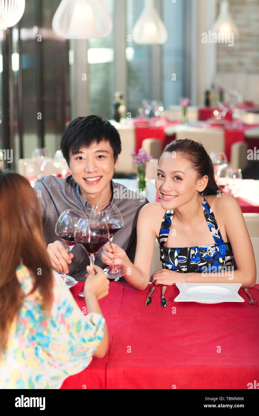 Three people are dining at a restaurant Stock Photo - Alamy