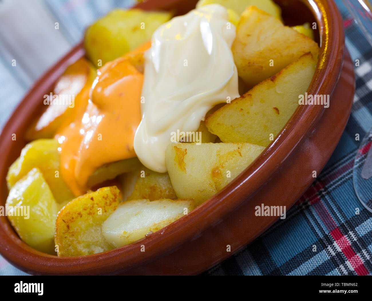 Patatas bravas with garlic mayonnaise and sauce Stock Photo Alamy