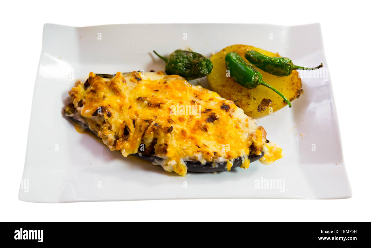 Appetizing baked eggplant stuffed with meat and bechamel sauce – spanish dish. Isolated over white background Stock Photo
