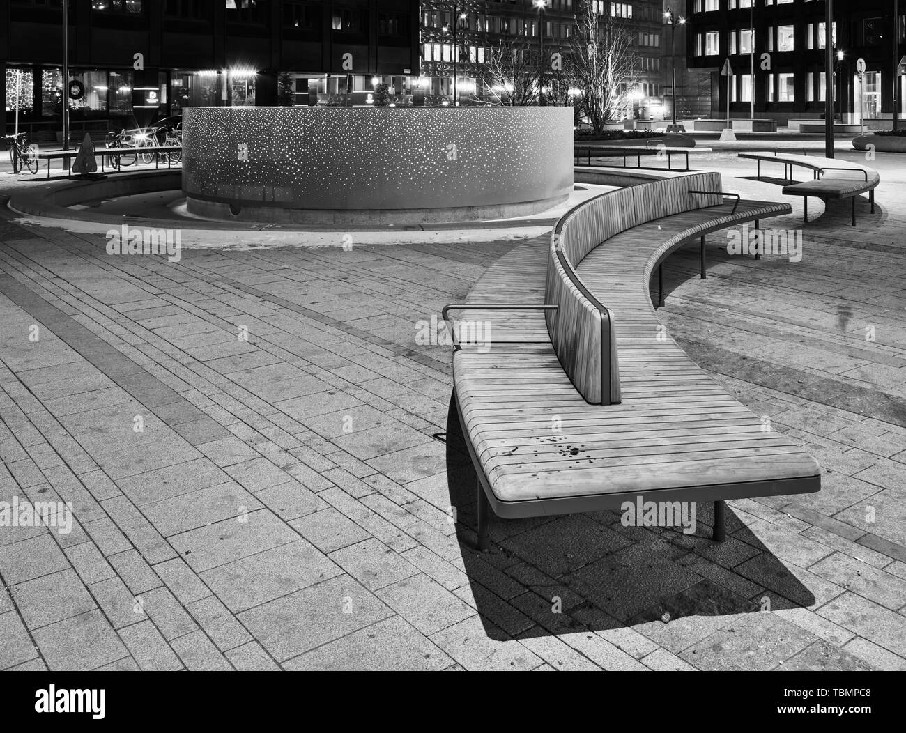 Curved benches around a fountain in Brunkebergstorg square, in Stockholm, Sweden Stock Photo