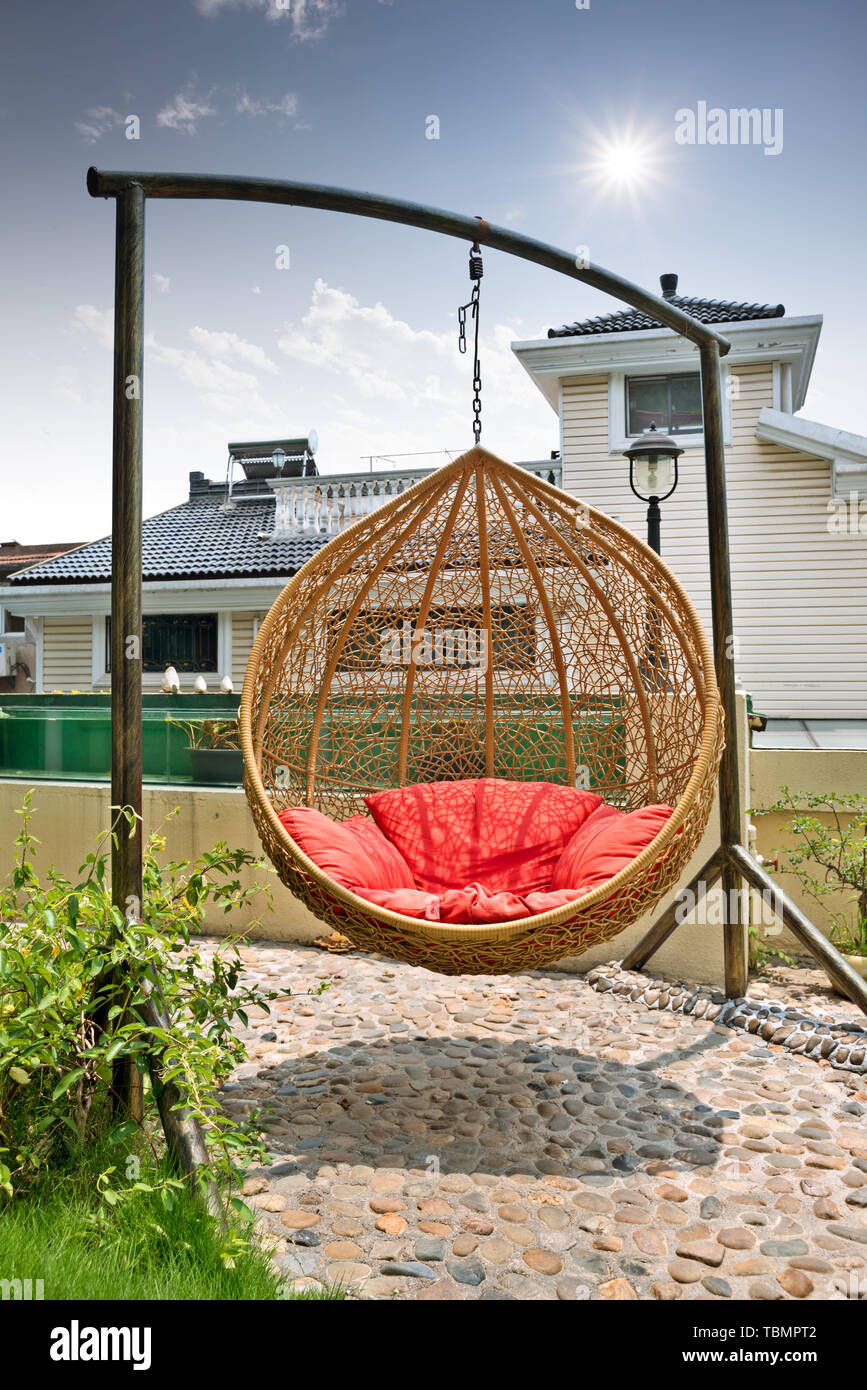 Hanging rattan swing hires stock photography and images Alamy