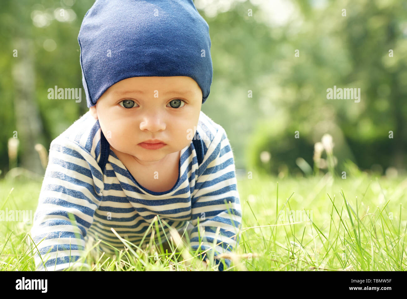 outdoor portrait of a baby on all fours. crawling on knees child on the