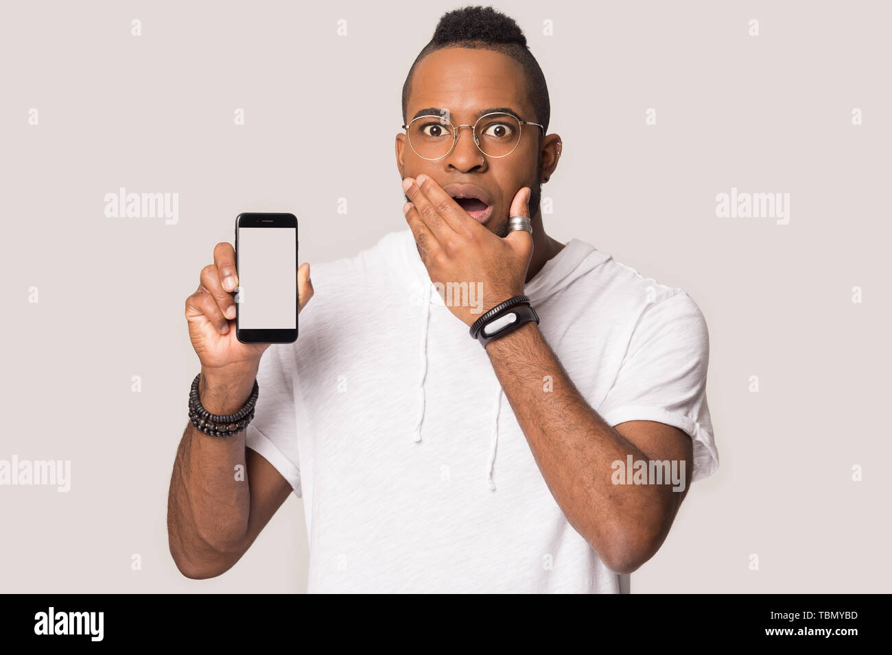 Happy black man using tablet shopping online in studio Stock Photo