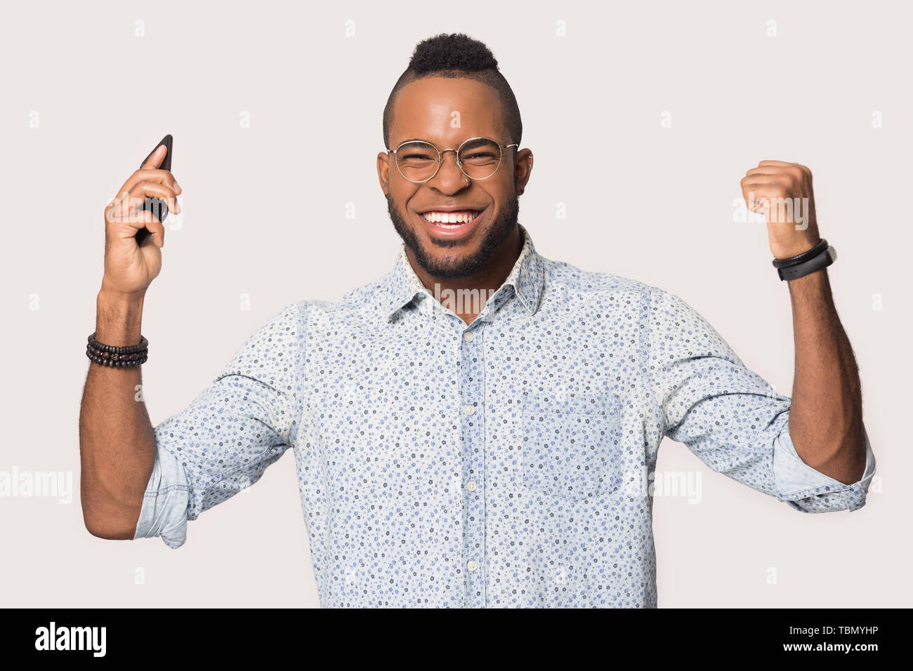 Surprised black man confused by unexpected message on smartphone Stock Photo