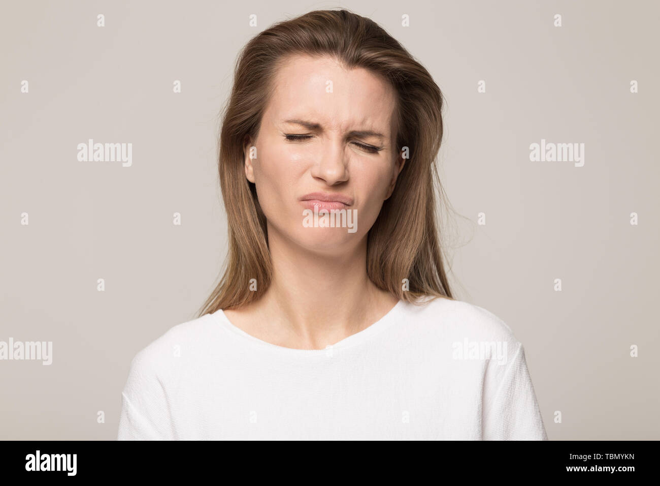Dissatisfied young woman look at camera showing discontent Stock Photo