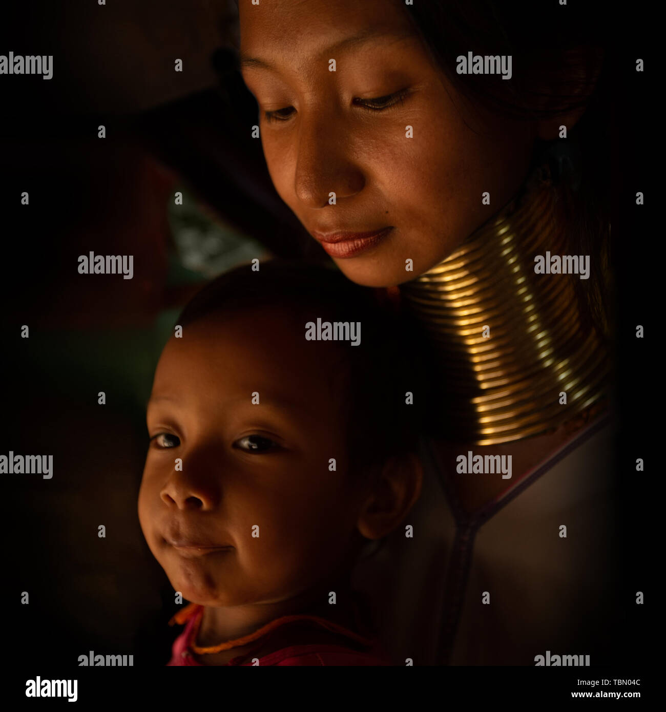 A Family from Kayan Lahwi tribe known for wearing neck rings. Stock Photo