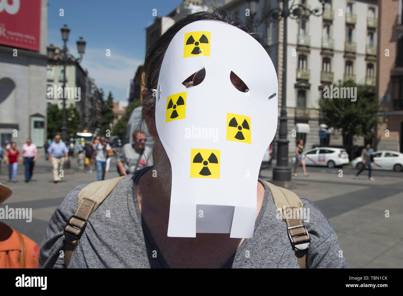 Activist with a face mask during protest. Ecologists from the Iberian Peninsula accompanied by activists from the United States, Turkey, France and Argentina, protested in Madrid for the closure of nuclear power plants, uranium mines and high-level radioactive waste management. In addition, activists have protested a new energy model to avoid cases such as Chernobyl in Ukraine and have demanded the closure of the Almaraz Nuclear Power Plant in Spain. Stock Photo