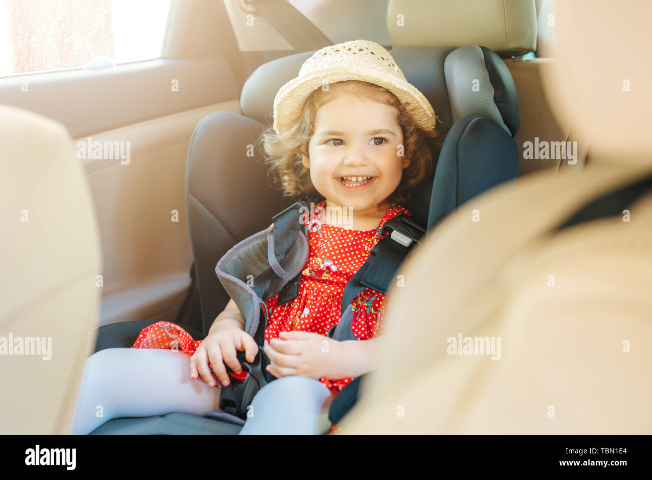 Cute little baby child sitting in car seat. Portrait of cute little baby child sitting in car seat.Safety concept Stock Photo