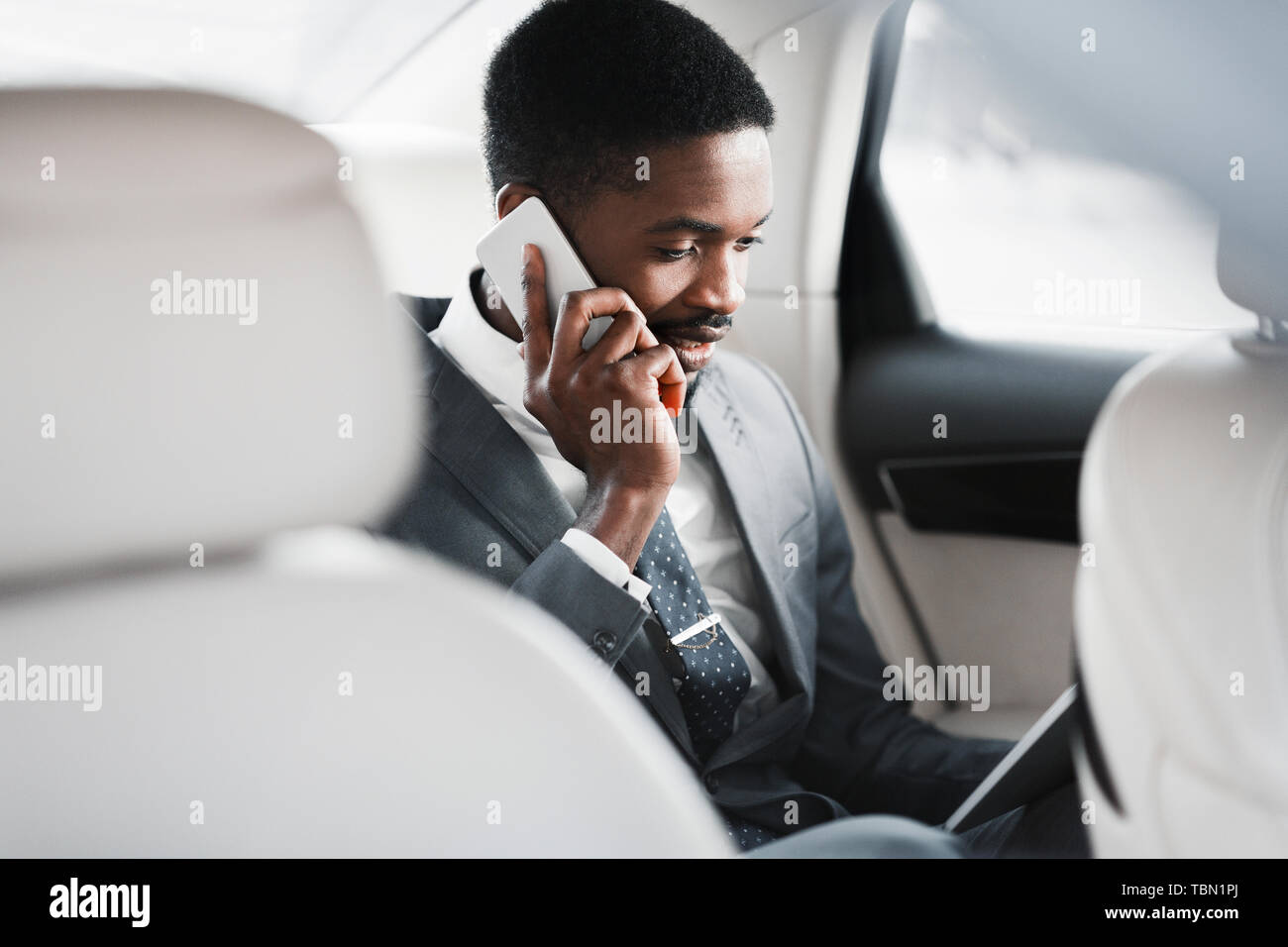 Business Trip. Man Talking On Phone And Discussing Work Stock Photo