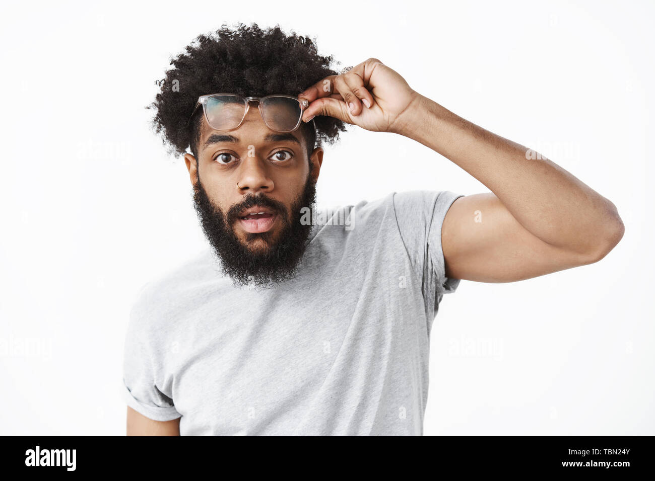 Impressed and surprised handsome african american guy taking off glasses as  being charmed by beauty holding eyewear on forehead open mouth from amazem  Stock Photo - Alamy