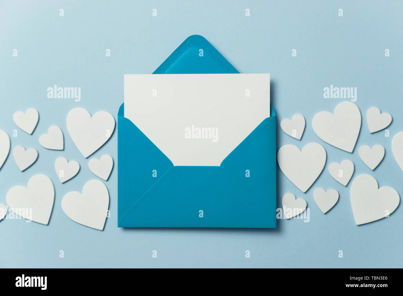 Father's Day card mockup. Blue envelope blank white card and hearts Stock Photo