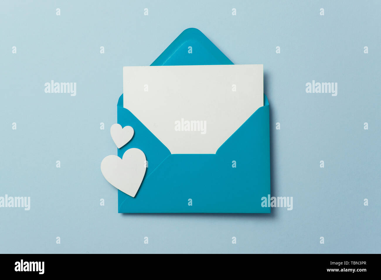 Father's Day card mockup. Blue envelope blank white card and hearts Stock Photo