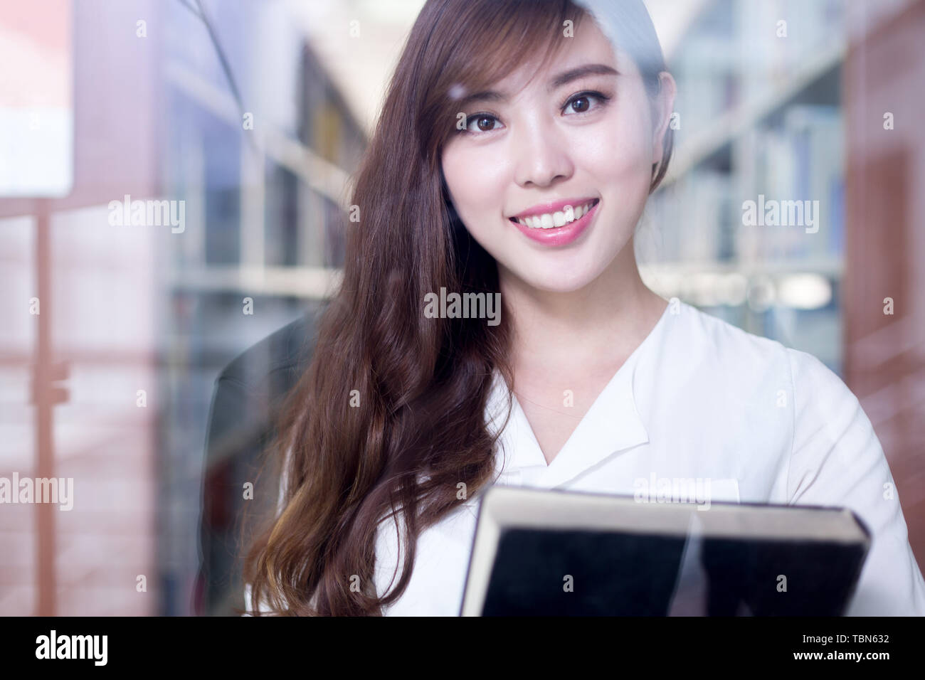 asian beautiful female student holding book in library portrait Stock ...