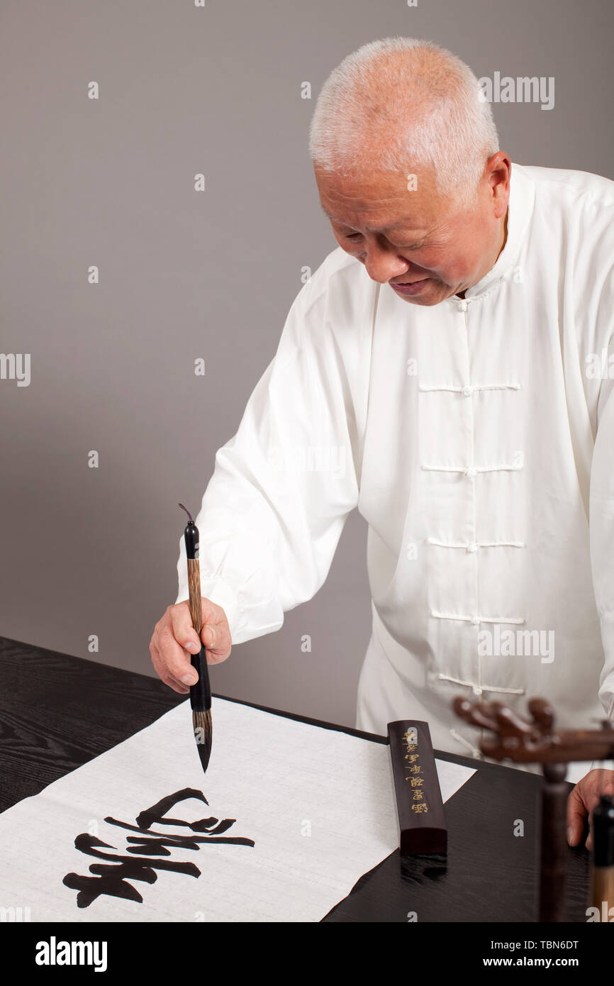 An old man practicing calligraphy Stock Photo - Alamy