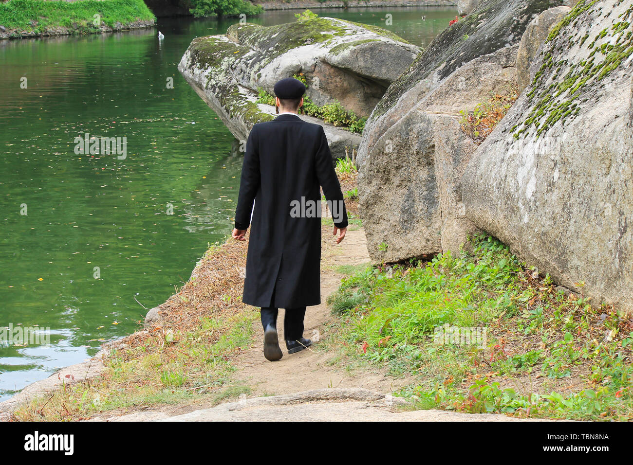 Hasidic Jew boy in black clothing walk in the park in Uman, Ukraine, the time of the Jewish New Year, Religious Jew, Orthodox Stock Photo