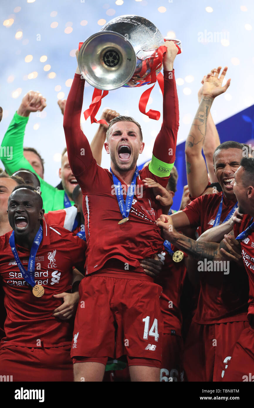Liverpool Captain Jordan Henderson Lifts The Trophy After The Final Whistleduring The Uefa