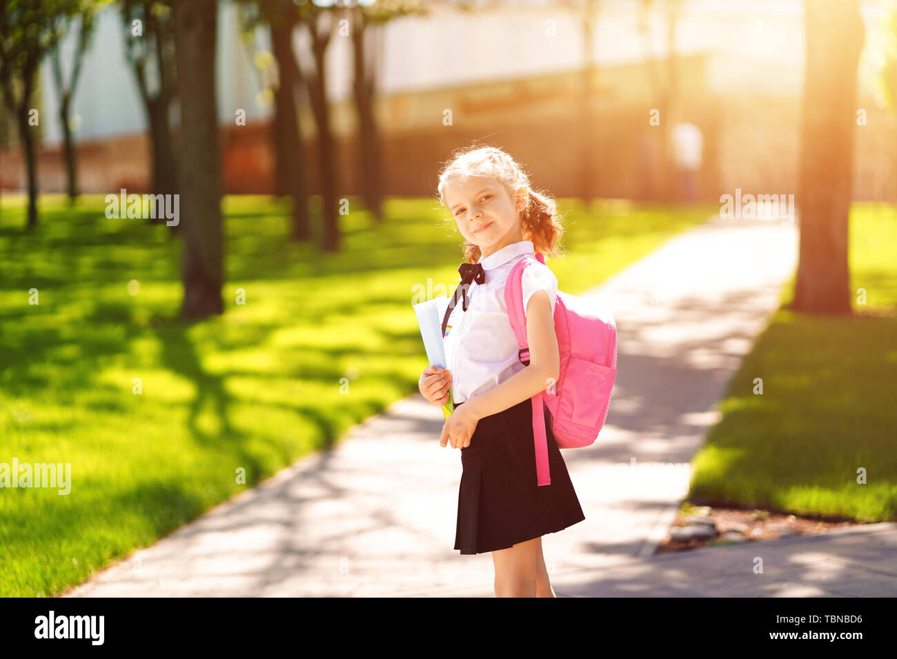 Beautiful little girl with backpack walking in the park ready back to ...