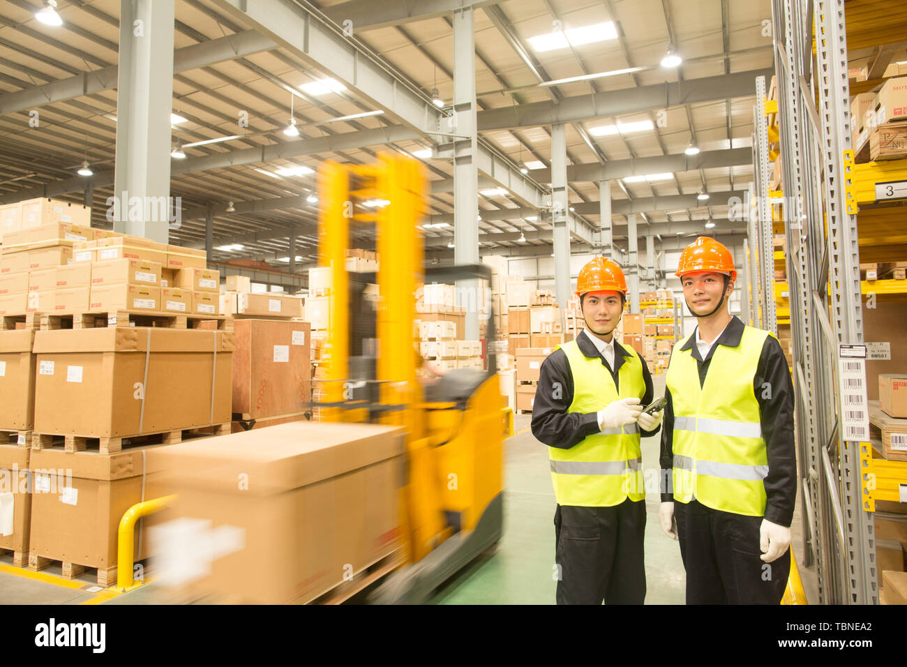 Logistics personnel load and unload cargo at the warehouse Stock Photo ...
