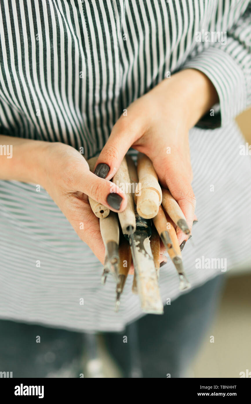 pottery tools for carving ceramic products in workshop Stock Photo