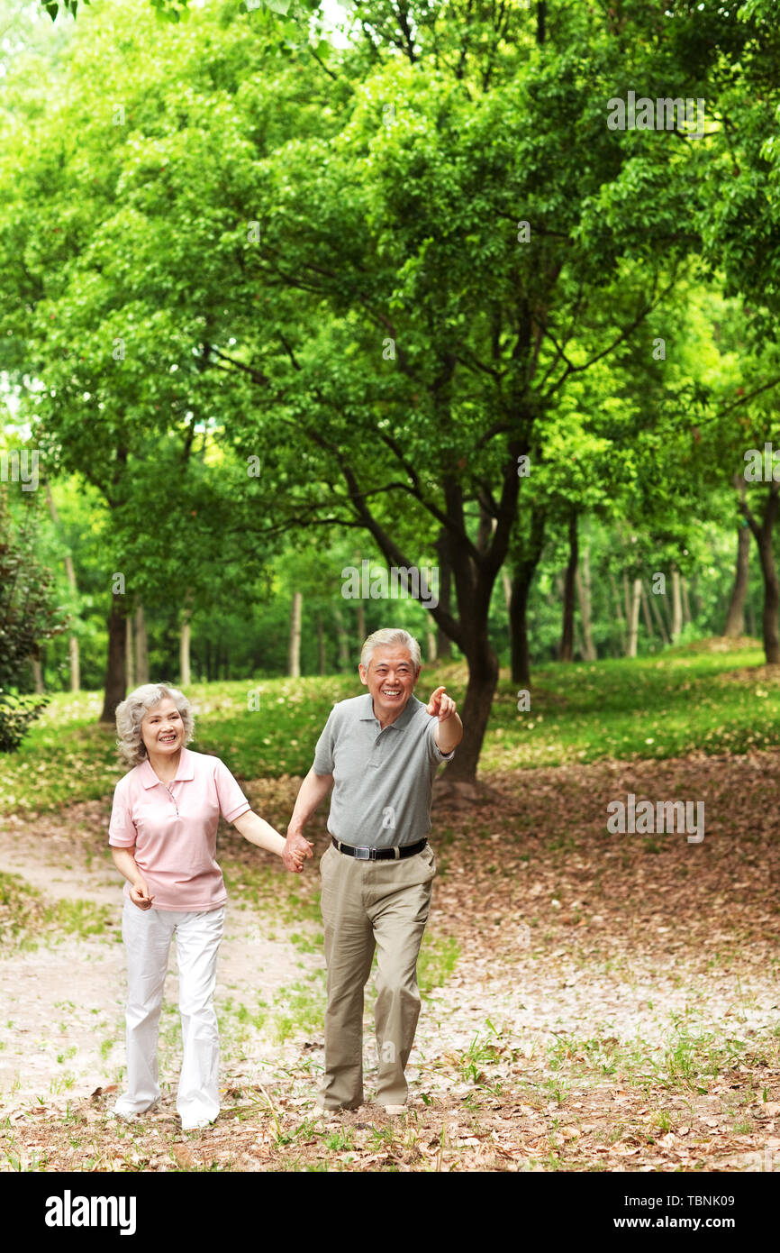 An elderly couple working out in a park Stock Photo