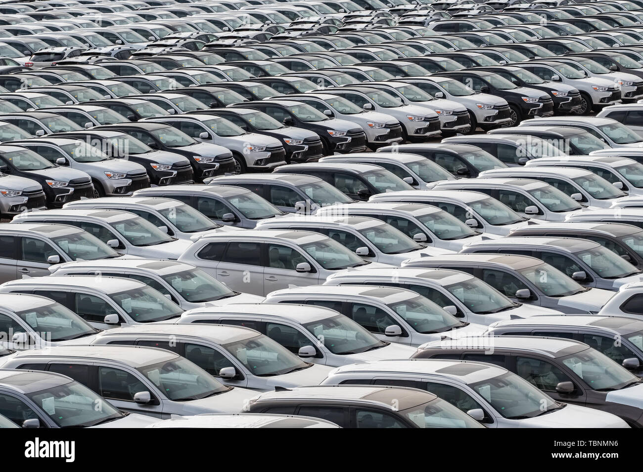 Row of new cars for sale in port Stock Photo