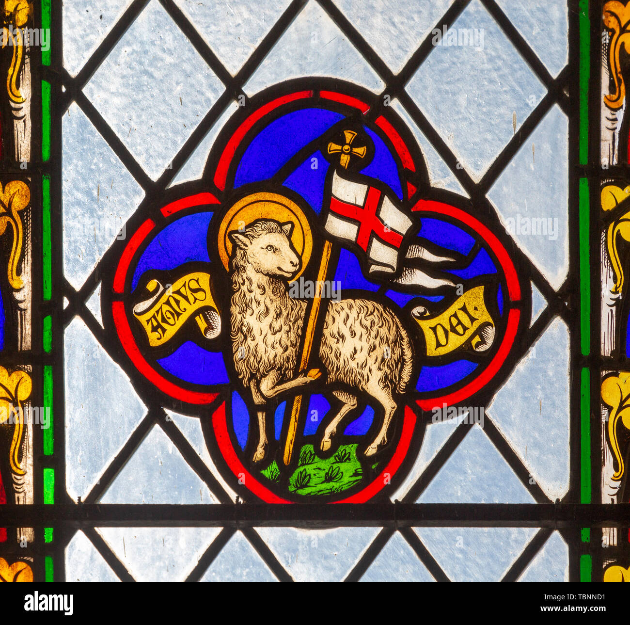 Close up of 19th century stained glass window in church of Saint Andrew, Wissett, Suffolk, England, UK - Lamb of God Stock Photo