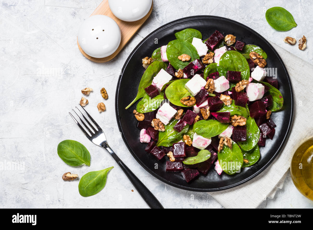 Fresh salad from spinach, beet and feta cheese with walnut. Stock Photo