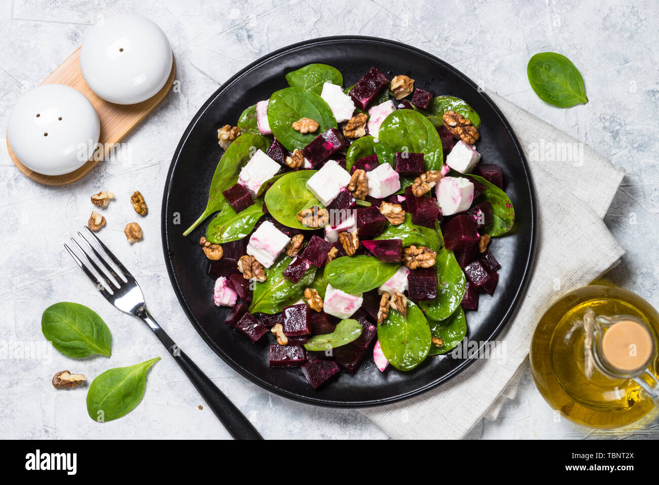 Fresh salad from spinach, beet and feta cheese with walnut. Stock Photo