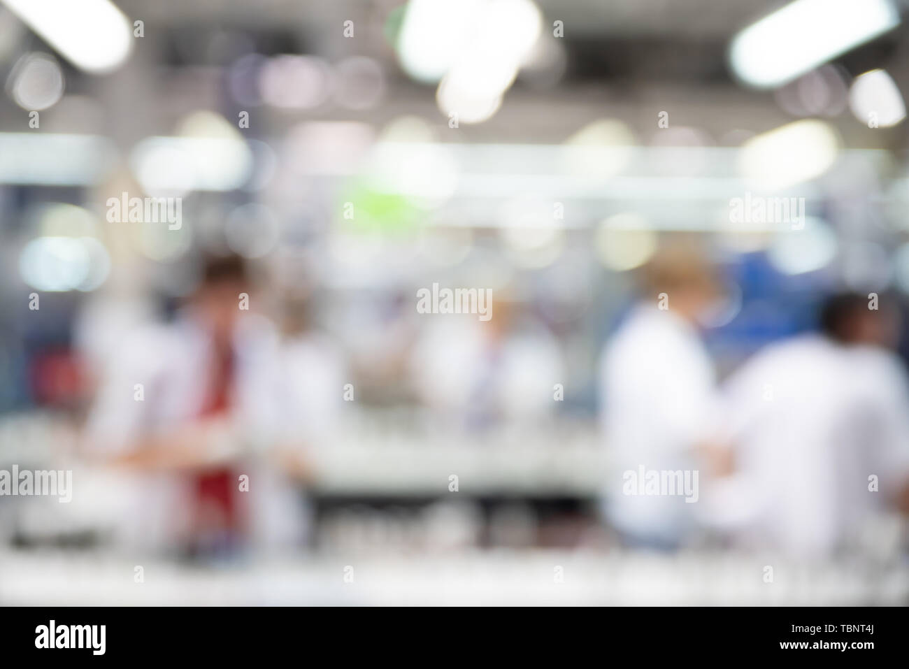 Abstract blurred industry background, workers on production line, blur technique. Stock Photo