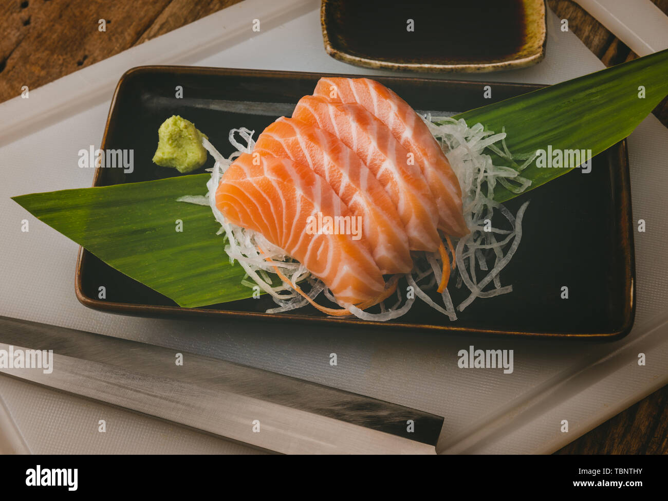 Salmon sashimi cut and slice arranging in Japanese style with grey tone