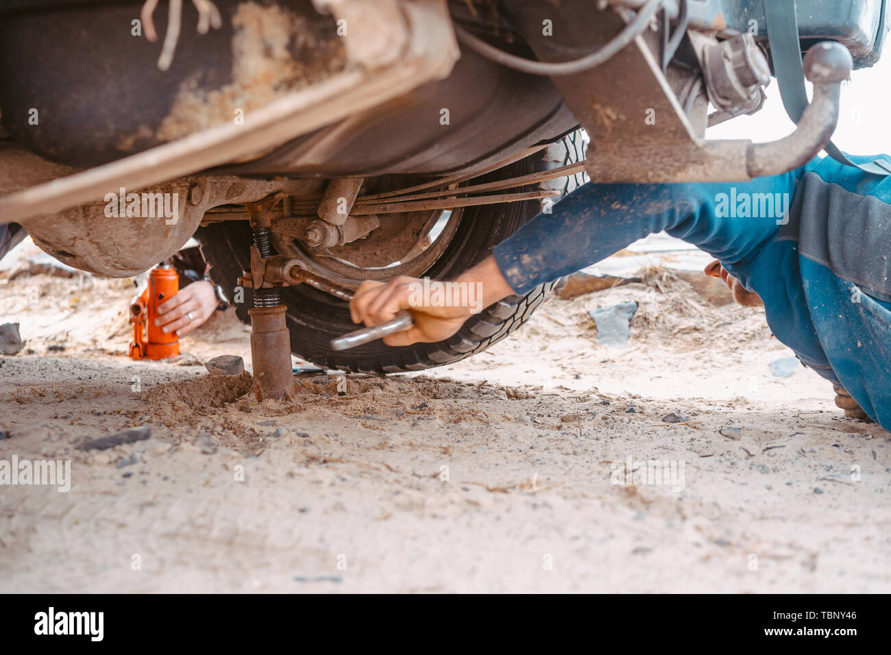 A Man Raises On A Jack 4x4 Off Road Truck Stock Photo 248188646