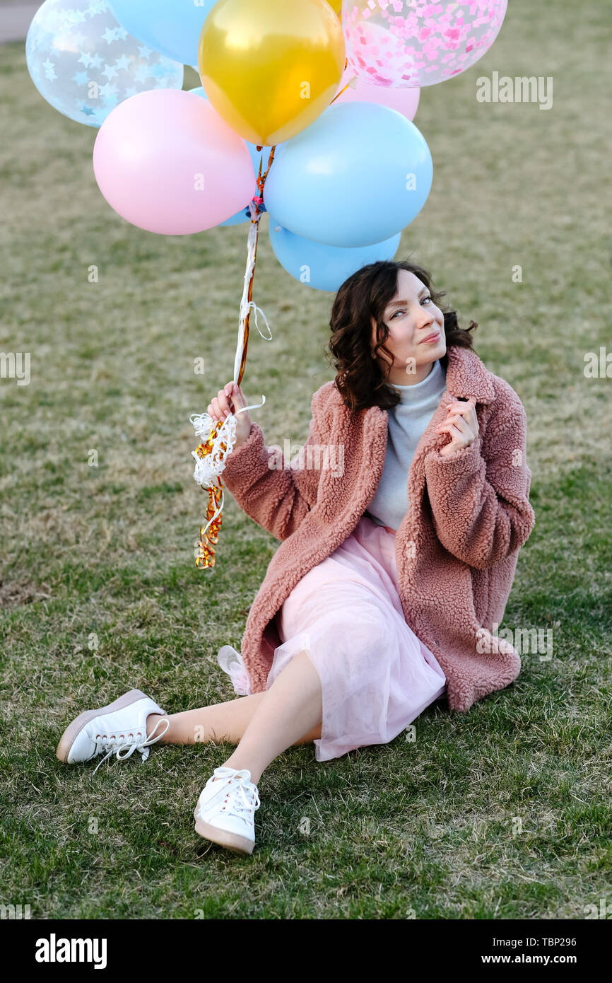 Happy young girl with air balloons in park Stock Photo - Alamy