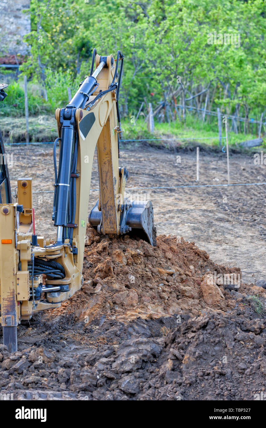 A backhoe excavating earth in a construction site Stock Photo Alamy
