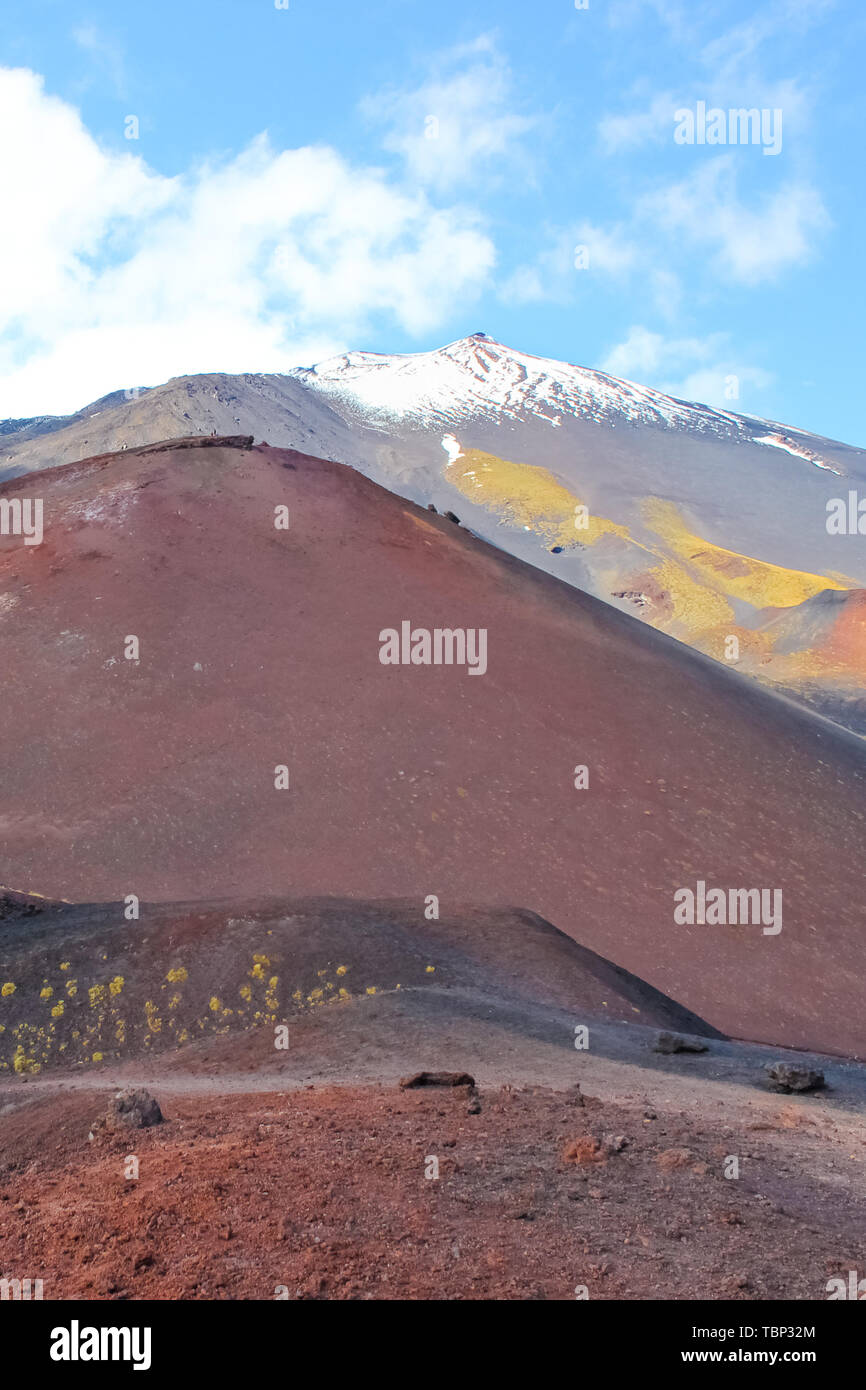 Beautiful volcanic landscape on famous Mount Etna. Snow on the very top of the mountain. European highest active volcano. Popular spot. Stock Photo
