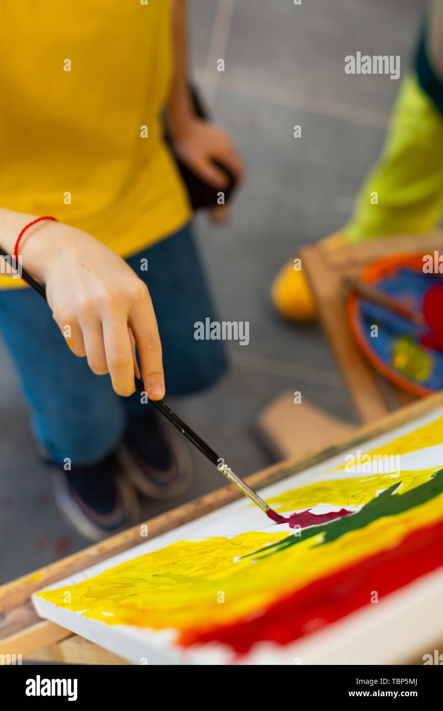 Boy holding painting brush hi-res stock photography and images - Alamy