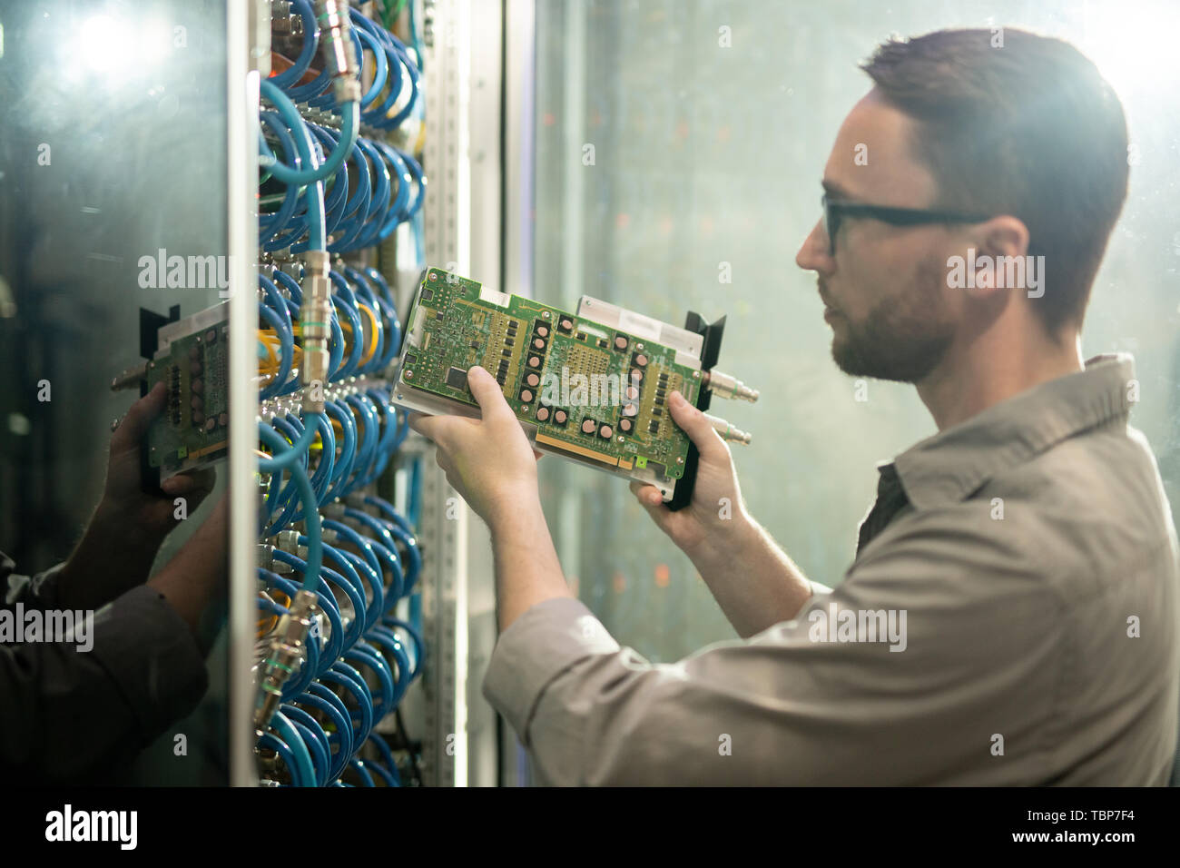 Serious concentrated young bearded server repair professional in ...