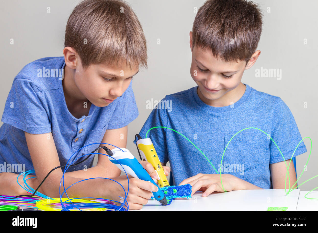 Children creating new items with 3d printing pens Stock Photo - Alamy