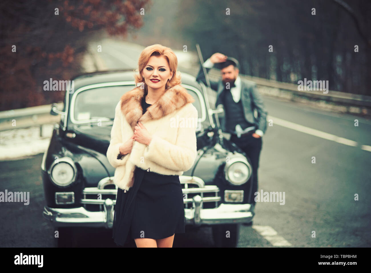 taxi on road with luxury couple. taxi driver and woman at retro car. Stock Photo