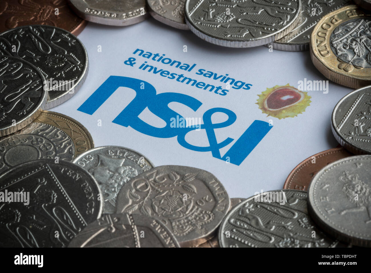 A form used to purchase NS&I Premium Bonds with the logo surrounded by coins. Stock Photo