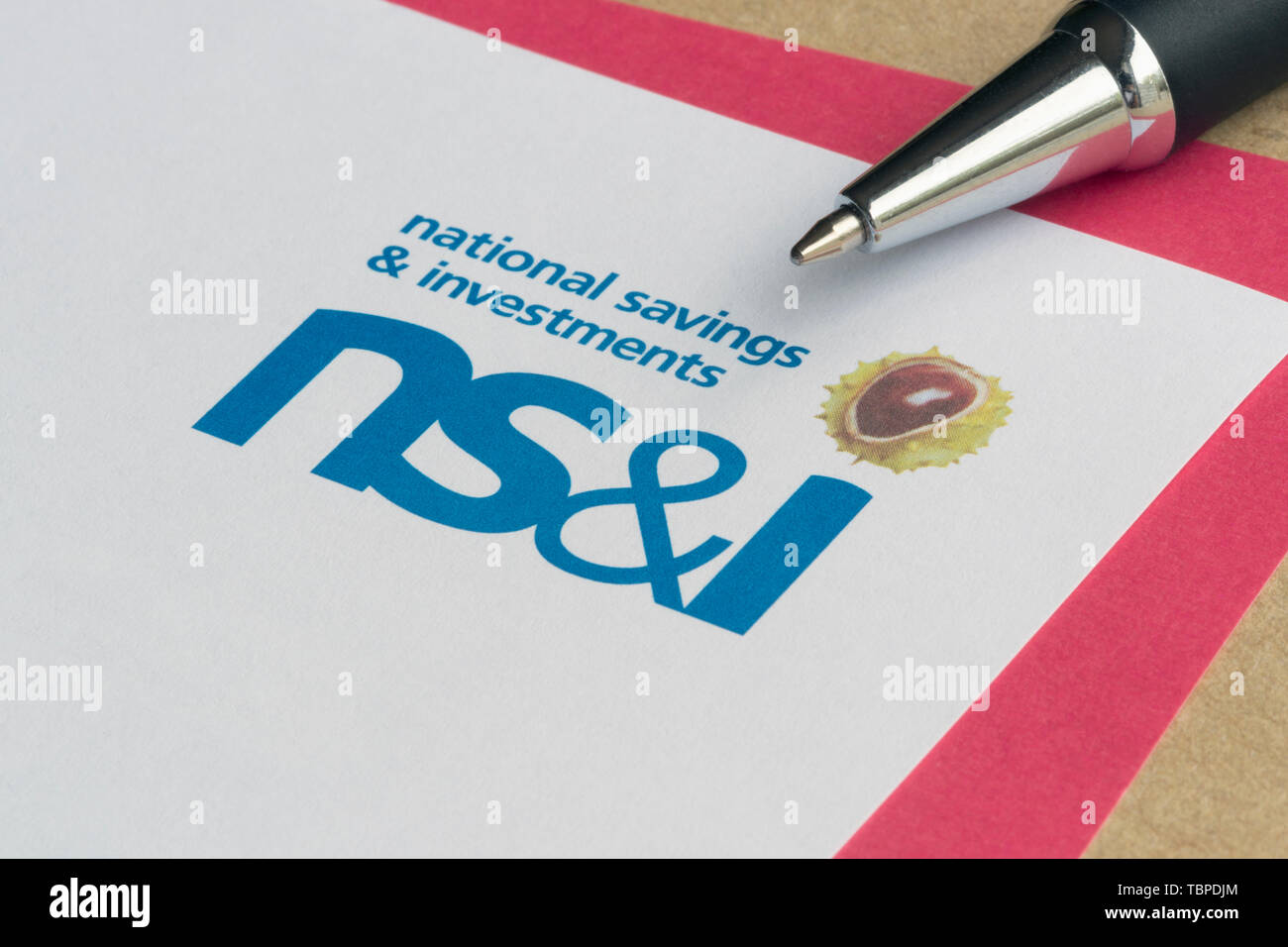A form used to purchase NS&I Premium Bonds together with an envelope and pen. Stock Photo