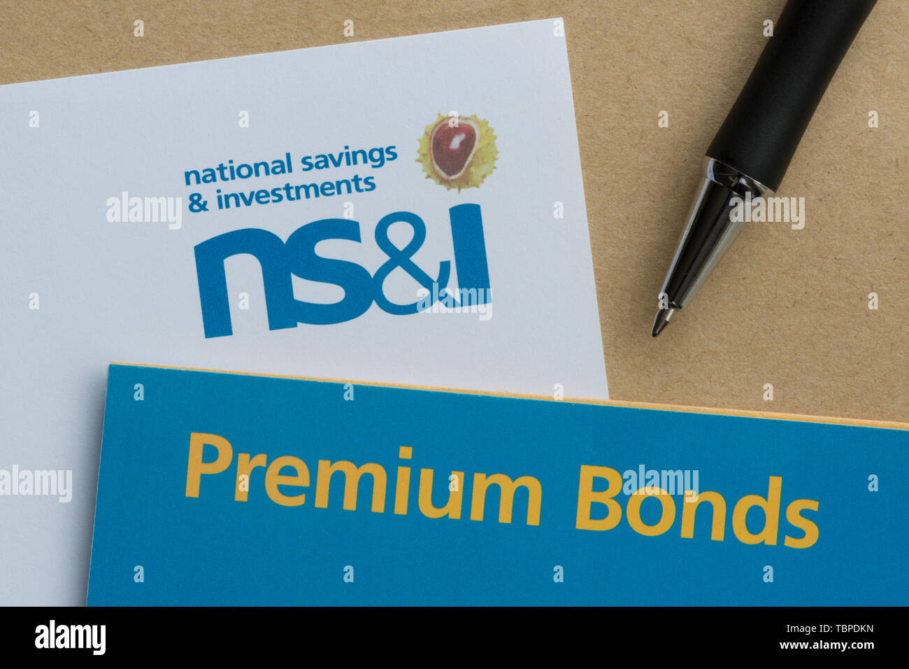 A form used to purchase NS&I Premium Bonds together with an envelope and pen. Stock Photo