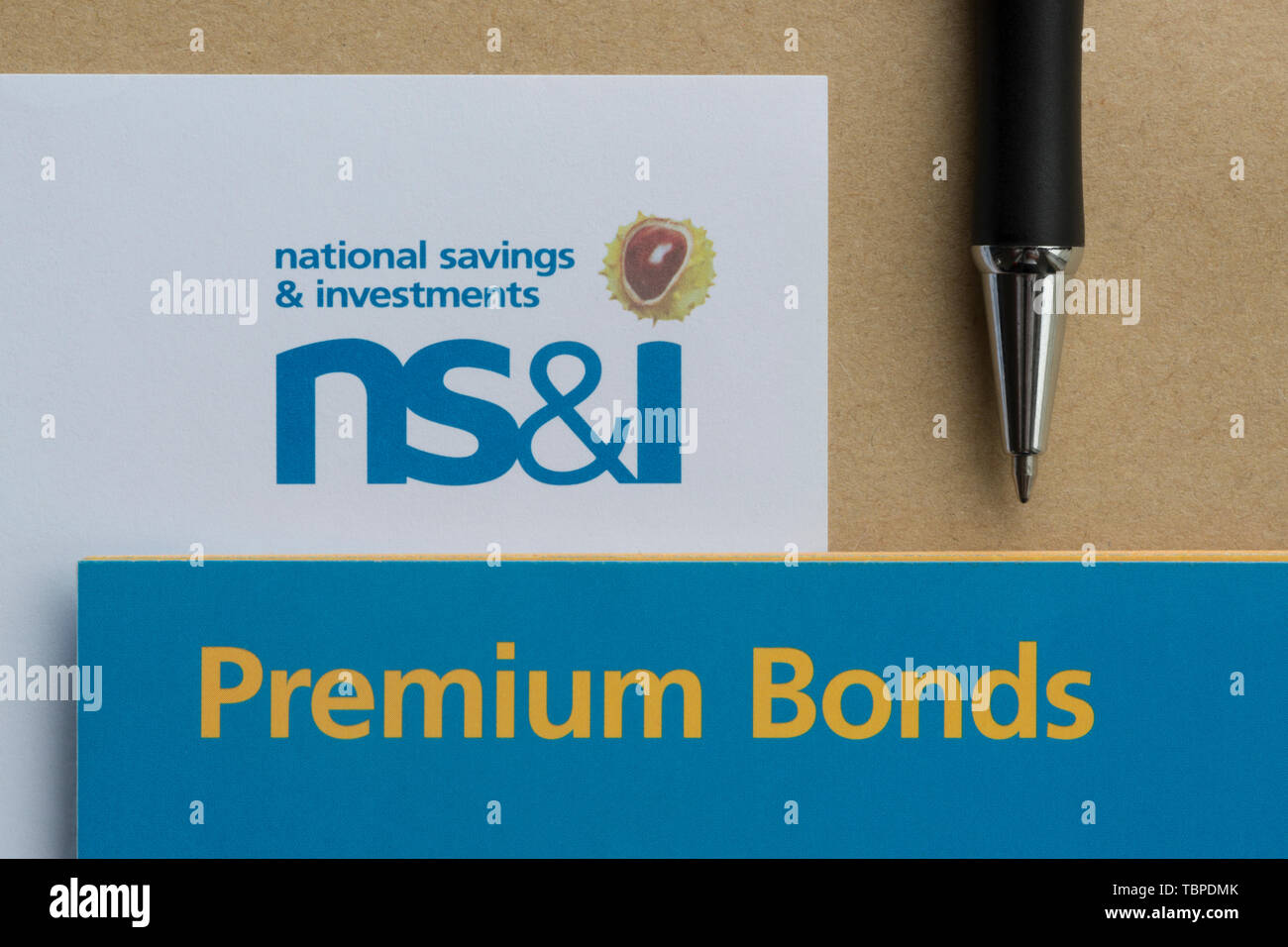 A form used to purchase NS&I Premium Bonds together with an envelope and pen. Stock Photo