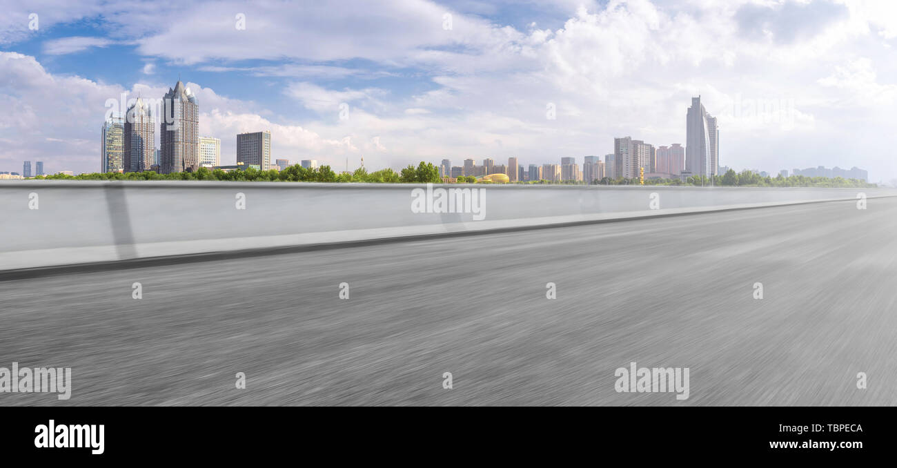 The foreground is the Zhengzhou urban landscape and urban skyline of asphalt road Stock Photo