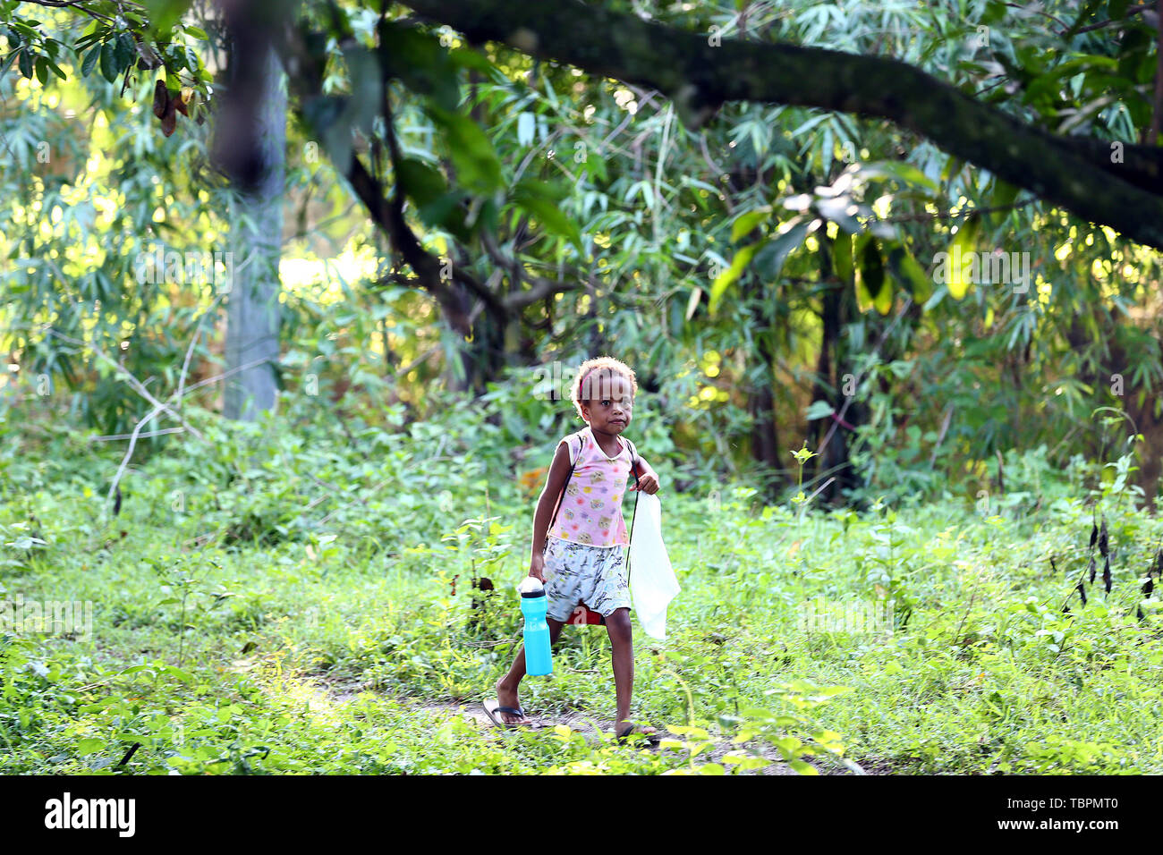 Pampanga Province, Philippines. 3rd June, 2019. A girl from the indigenous group 'Aeta' walks to school during the first day of classes in temporary classrooms of Diaz Elementary school in Pampanga Province, the Philippines, June 3, 2019. Temporary classrooms were set up after the Aeta community's classrooms were destroyed by the earthquake last April, as today marks the first day of new school year in the Philippines. Credit: Rouelle Umali/Xinhua/Alamy Live News Stock Photo