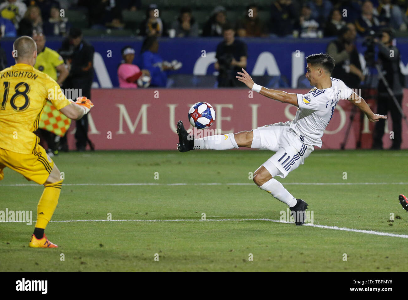 Los Angeles, California, USA. 2nd June, 2019. LA Galaxy midfielder Favio Alvarez (11) of Argentia, kicks the ball against New England Revolution goalkeeper Brad Knighton (18) during the 2019 Major League Soccer (MLS) match between LA Galaxy and New England Revolution in Carson, California, June 2, 2019. Credit: Ringo Chiu/ZUMA Wire/Alamy Live News Stock Photo