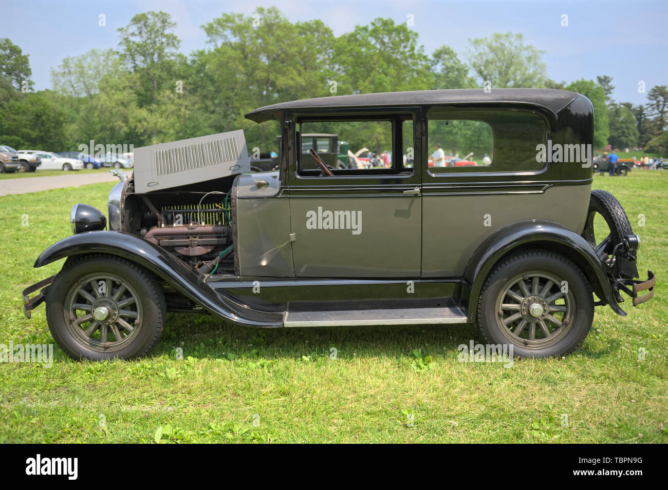 Old Westbury, New York, USA. 2nd June, 2019. The gray 1928 Studebaker Dictator, Club Sedan, owned by Keith Gramlich of East Meadow, is a vintage car entry on display with its hood folded open, at the 53rd Annual Spring Meet Antique Car Show, sponsored by the Greater NY Region (NYGR) of the Antique Car Club of America (AACA), at Old Westbury Gardens, a Long Island Gold Coast estate. Credit: Ann Parry/ZUMA Wire/Alamy Live News Stock Photo